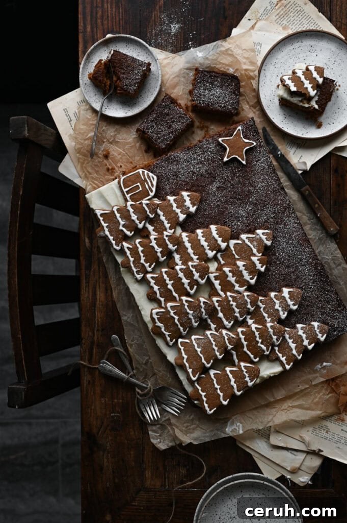 Chocolate cake covered in tree shaped gingerbread cookies.