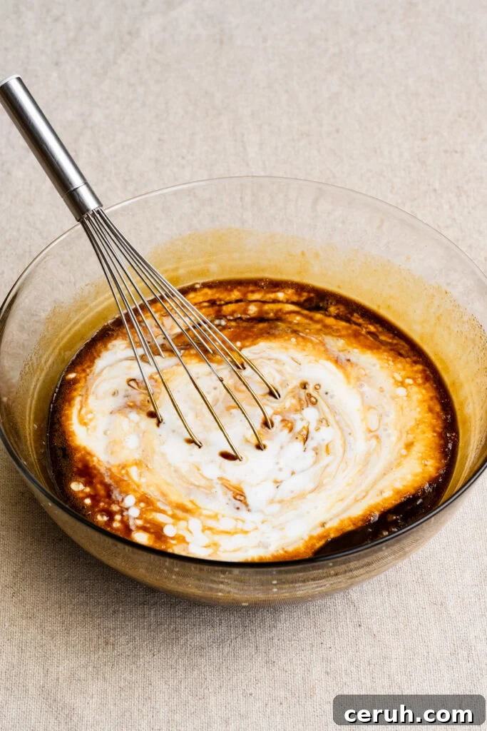 Whisk in a bowl of buttermilk and molasses cake batter.