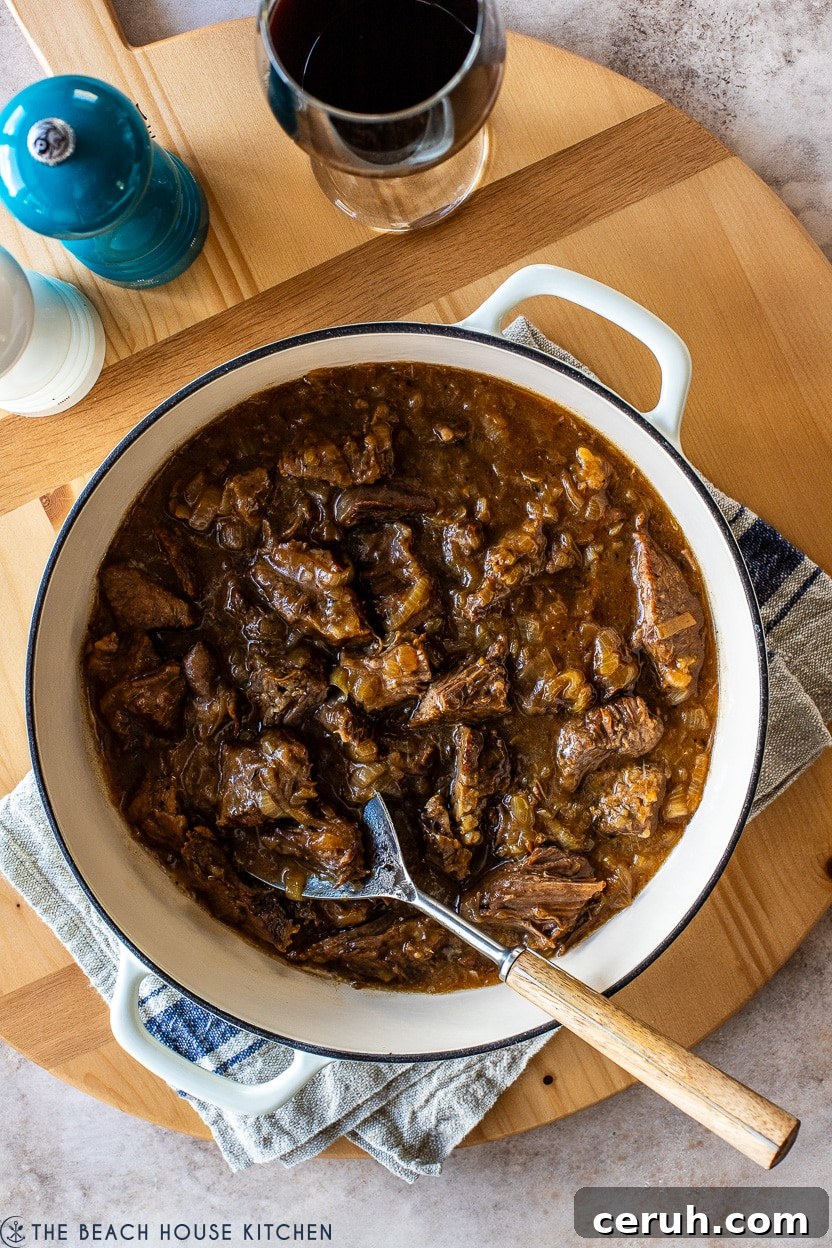 Overhead photo of a French onion pot roast in a Dutch oven