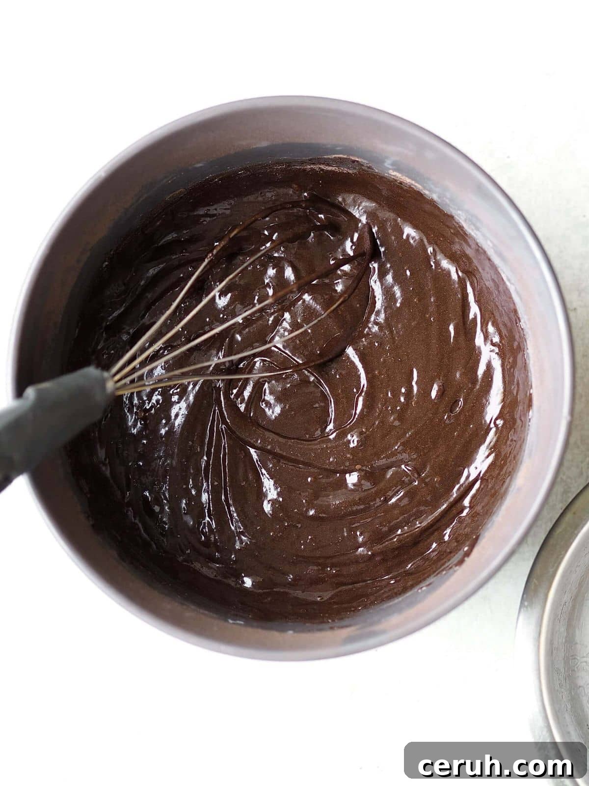 whisking together chocolate cake mix.