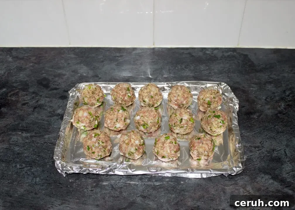Turkey meatballs rolled into balls on a foil lined baking tray