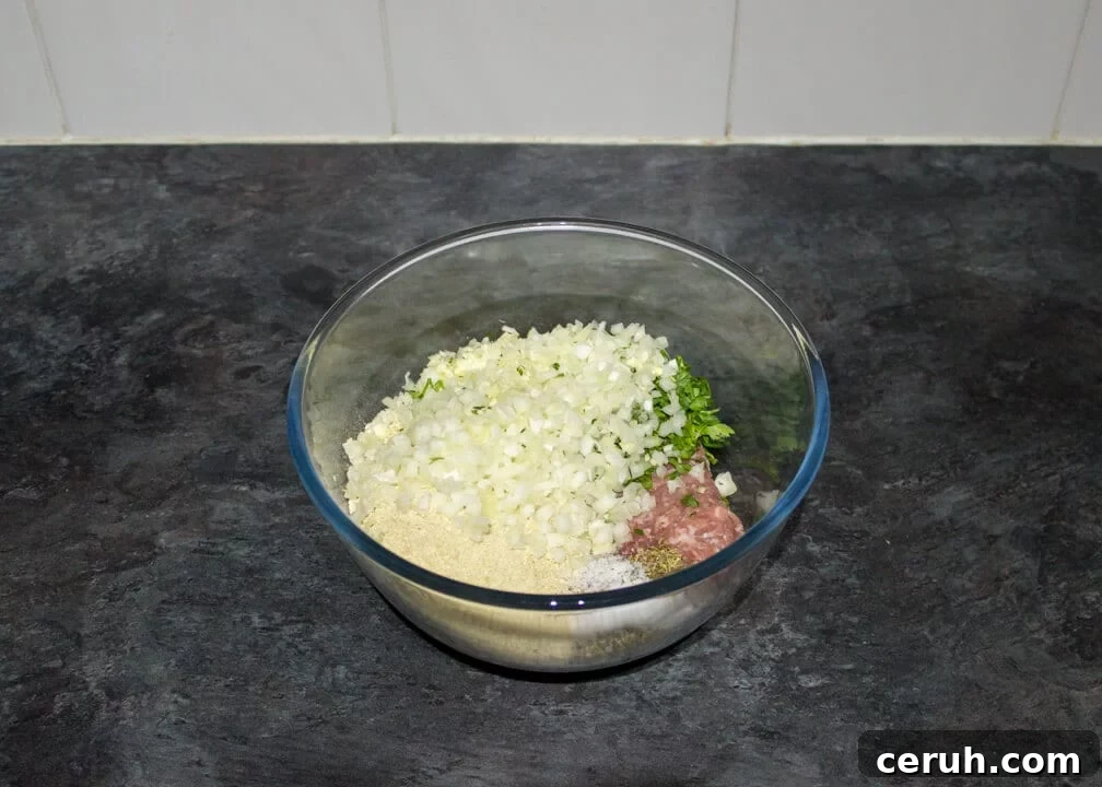 Slow cooker meatballs mixture in a glass bowl unmixed