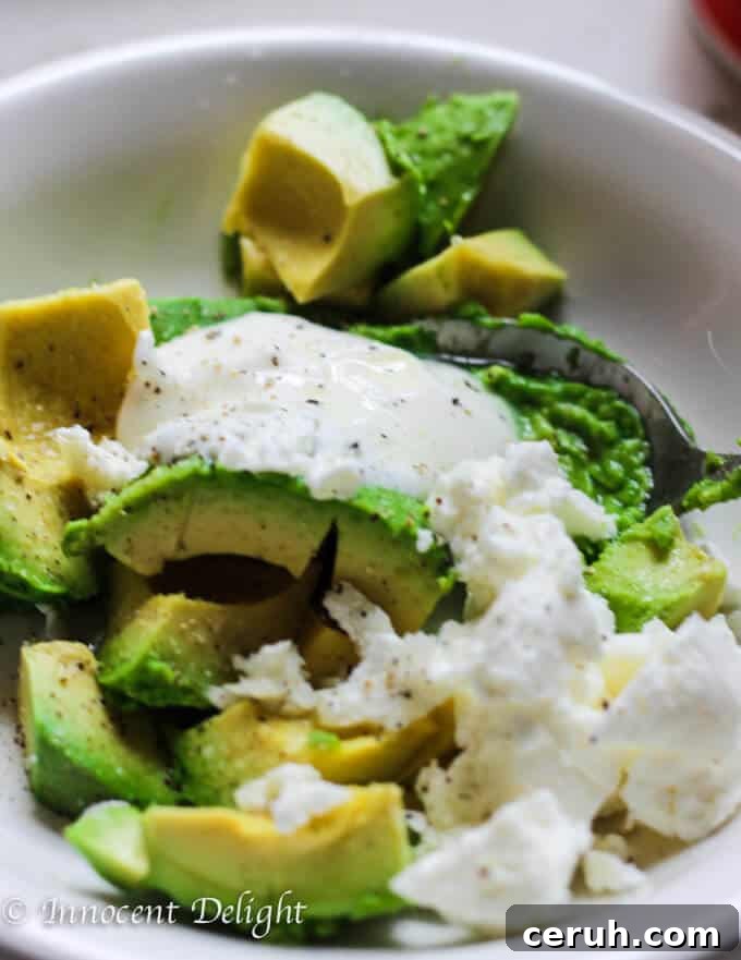 Assembled smashed avocado and poached egg toast