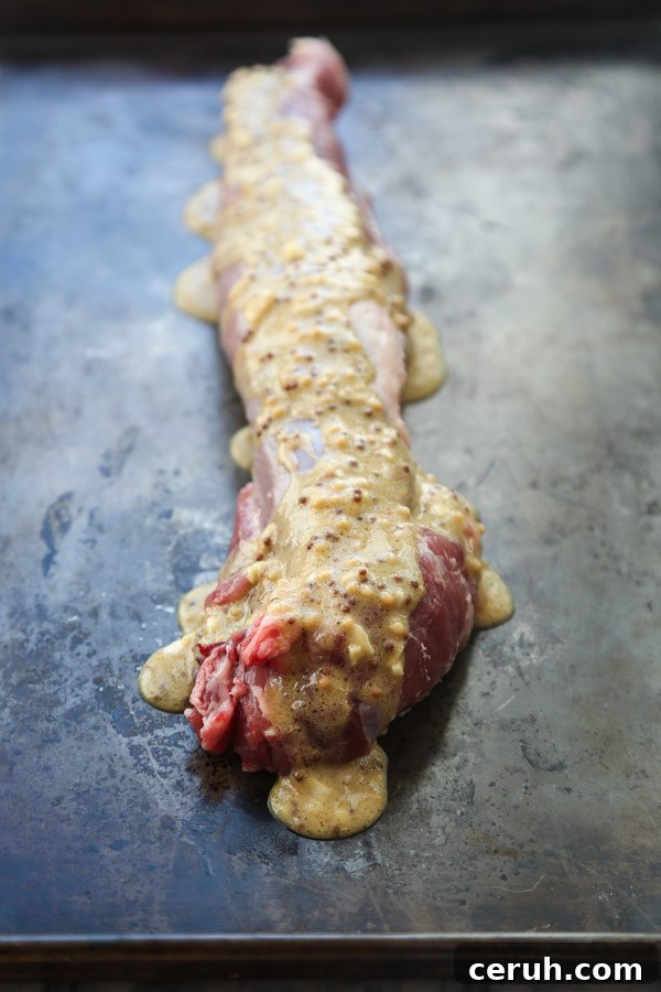 pork tenderloin on a sheet pan with mustard marinade
