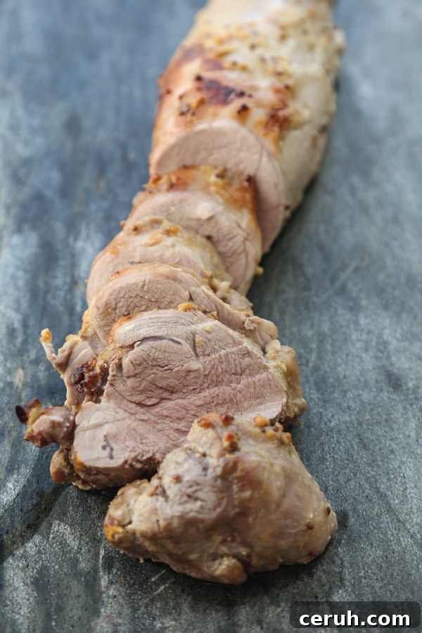 roasted pork tenderloin sliced on a sheet pan