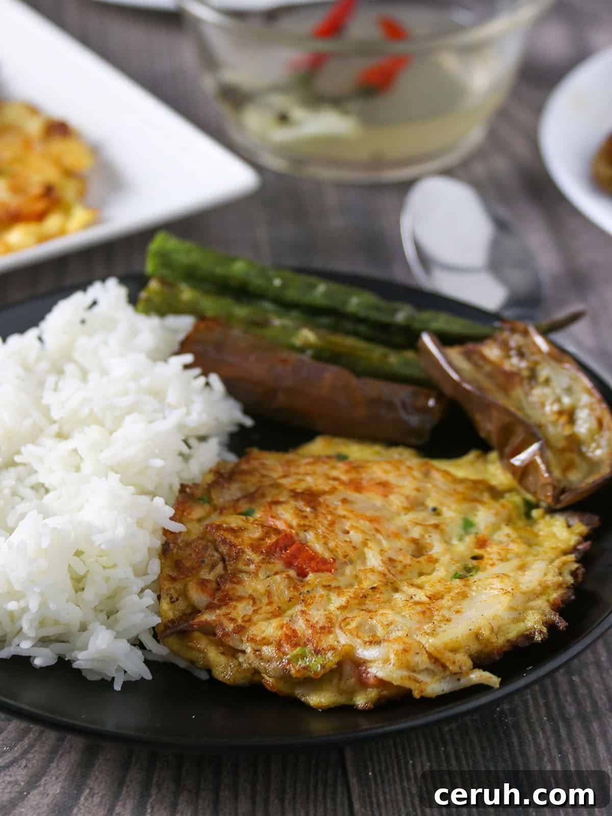 Tortang Dulong on a serving plate with fried eggplant and steamed okra on the side