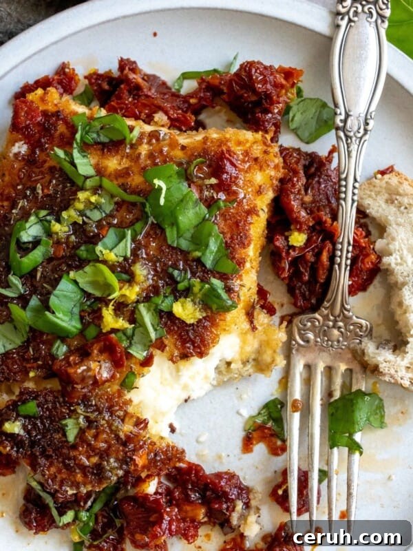 Pan Fried Feta on a plate with a fork.