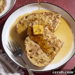 Syrup pouring onto a slice of Sourdough French Toast.