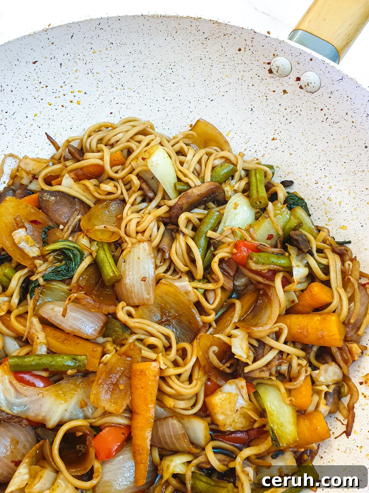 Vegetable lo mein in a frying pan.