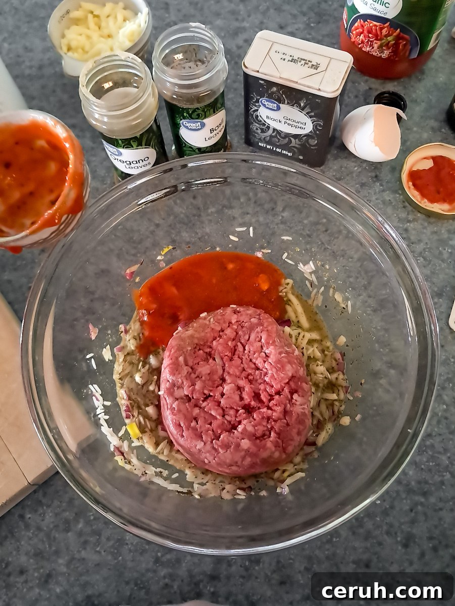 Mixing the ground beef and seasonings with sauce and egg in a small bowl.