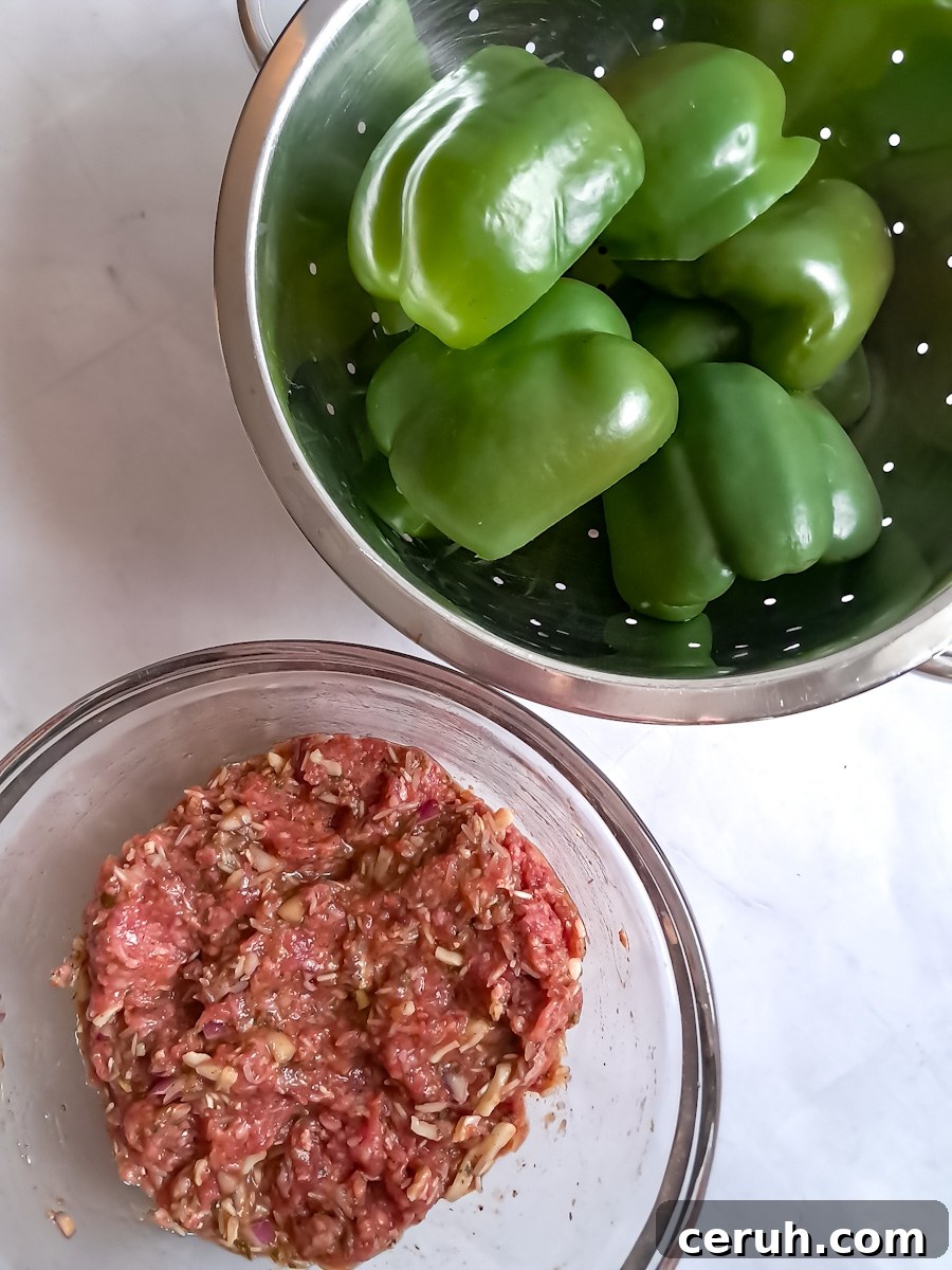 draining the boiled peppers in a colander, and the ground beef mixture in another bowl.