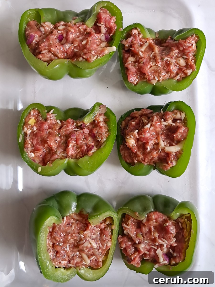 stuffed peppers in a baking dish ready for the oven.