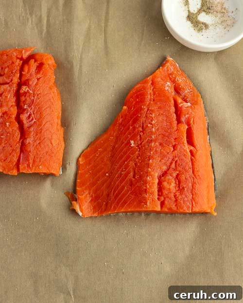 Seasoned salmon fillets in a baking dish.