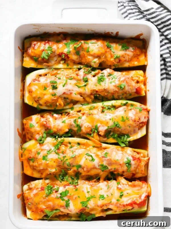 overhead view of zucchini boats in a white casserole
