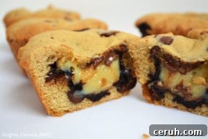 Cookie cups set in a muffin tray, ready to be filled with hot fudge and caramel.