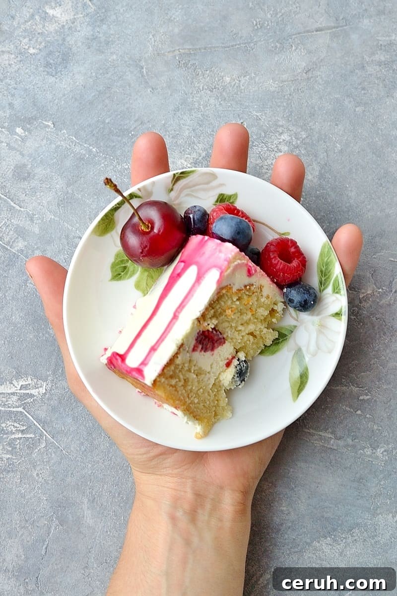 Mini white chocolate berry drip cake - delicious, moist vanilla cake with whipped white chocolate gananche, pink white chocolate drip and fresh berries; serves just 2-4 people!