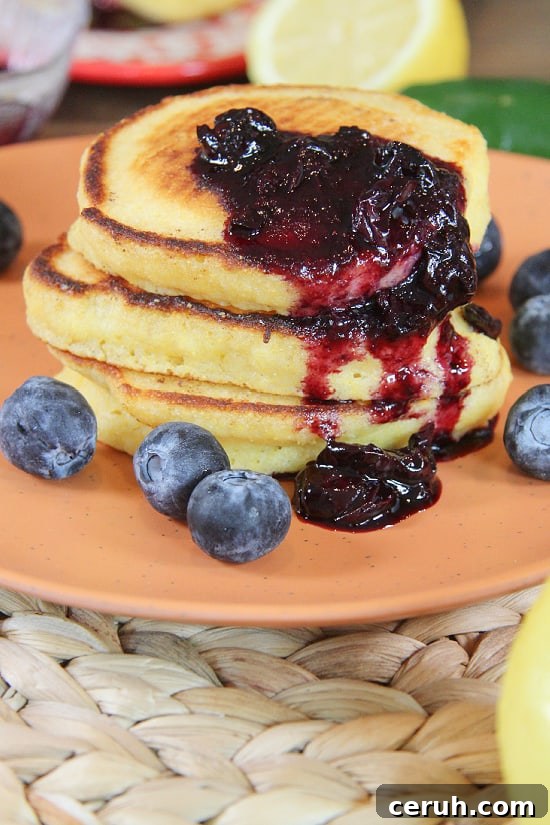Stacked breakfast treat topped with blueberries and jalapeños.