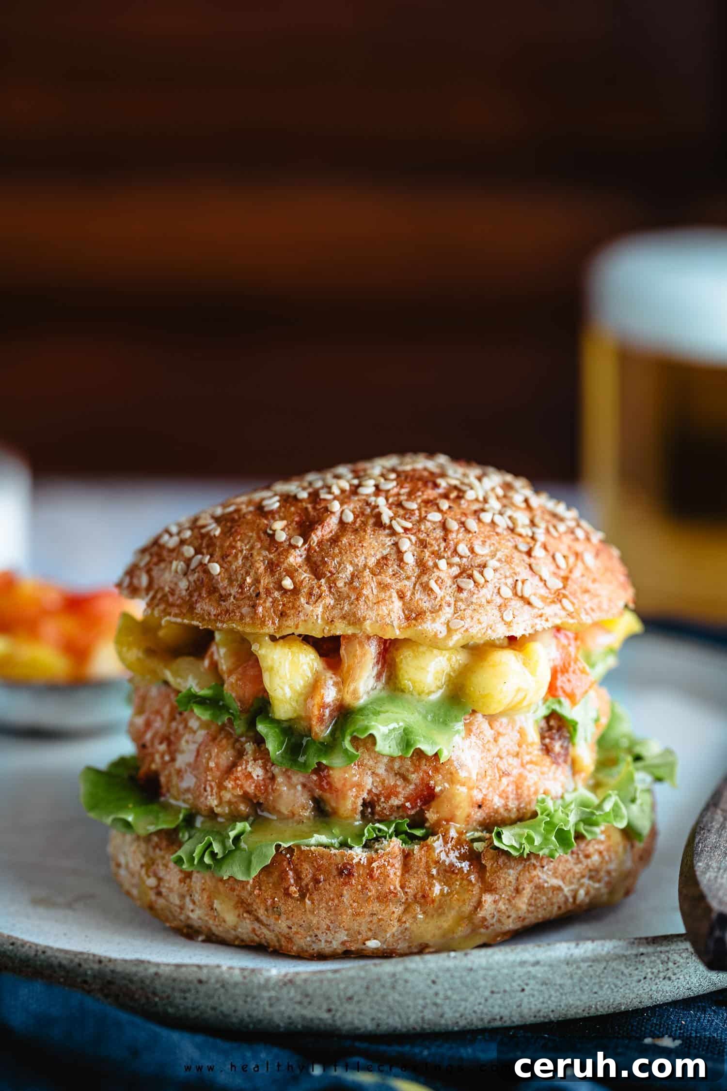 Grilled salmon burger with mango on a plate