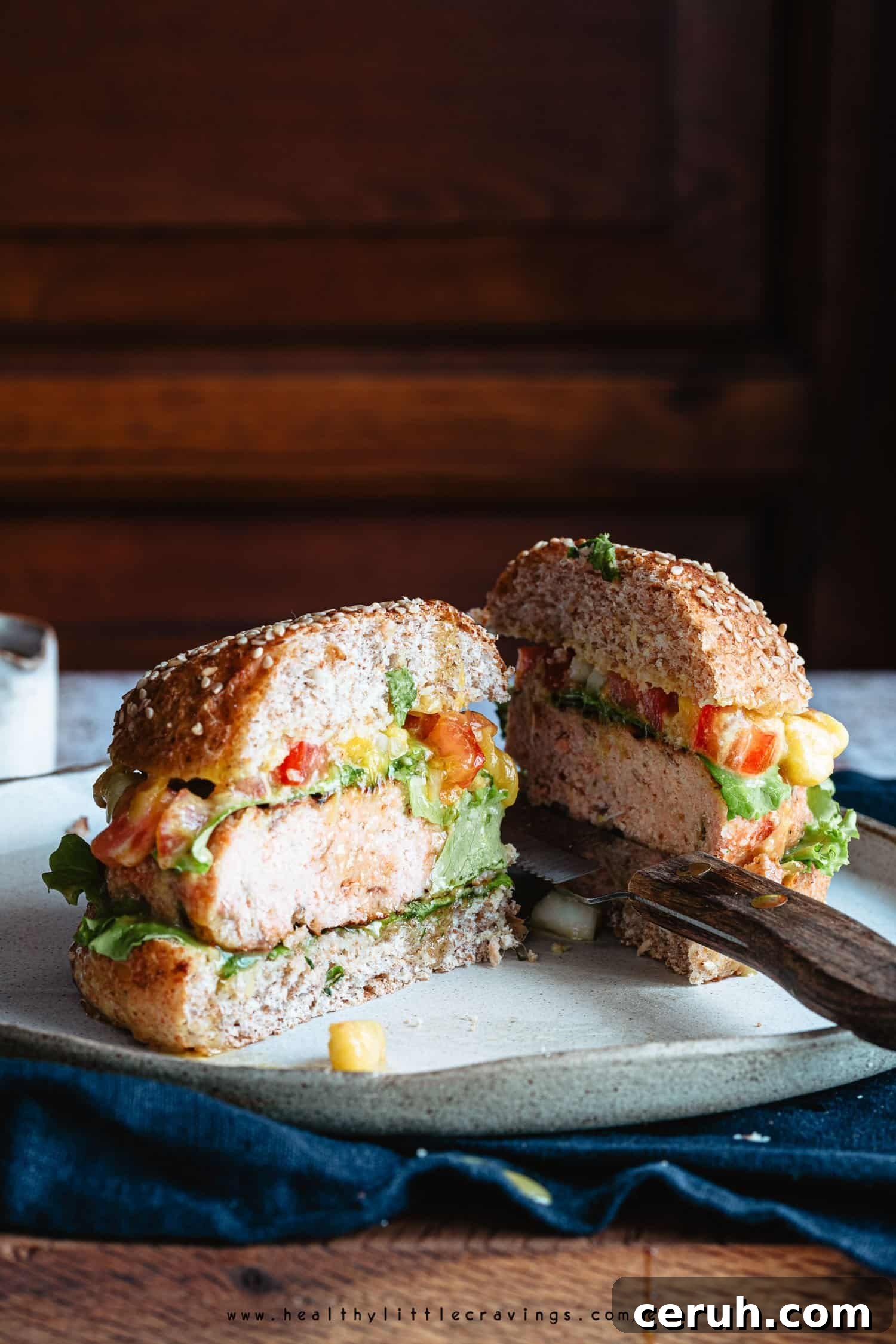Grilled salmon burger on whole wheat bread with mango salsa