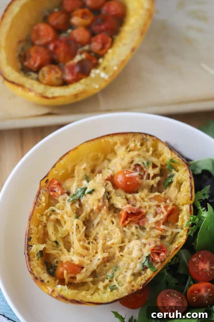 A plate with baked spaghetti squash with feta and tomatoes.