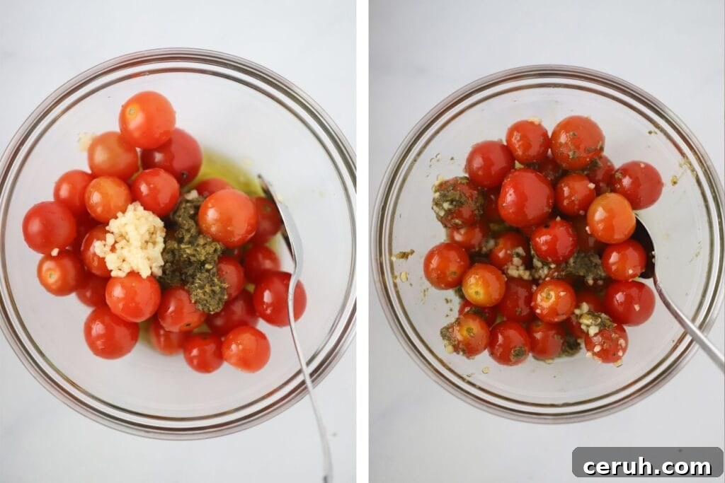 A glass bowl with cherry tomatoes, garlic, and pesto.