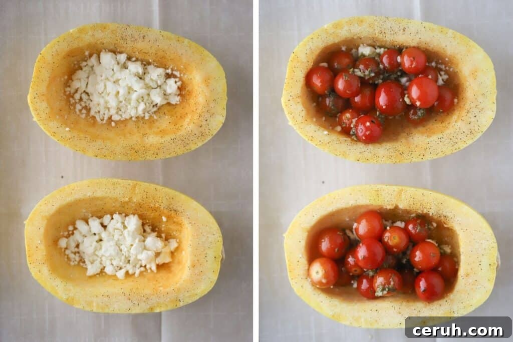 Squash halves filled with feta cheese and tomatoes, resting on a baking sheet.