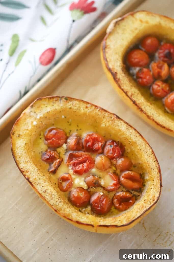 Half of a roasted spaghetti squash with tomatoes and feta.