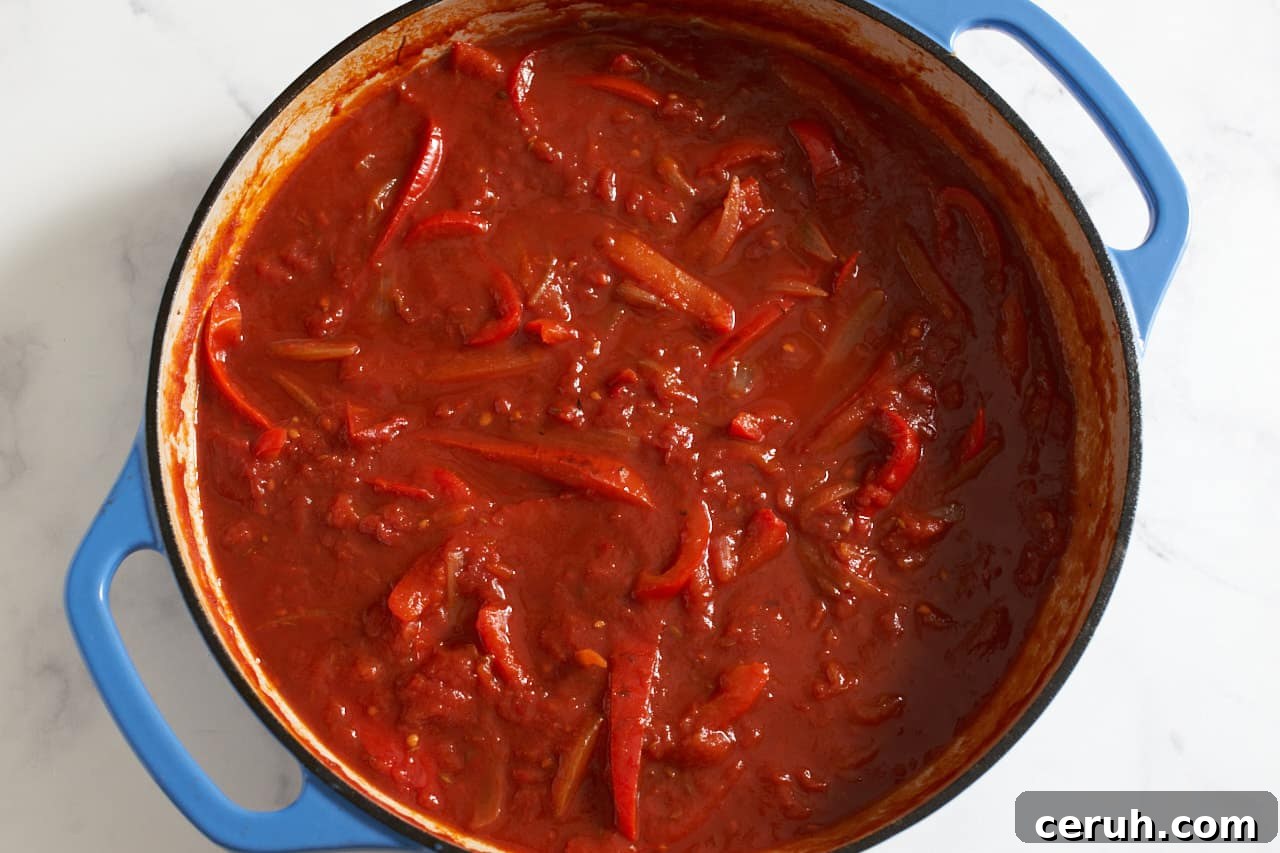 Finished tomato sauce for shakshuka in a blue pan.